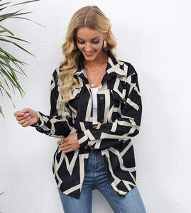 Detailed view of women's long sleeve jacket featuring bold black and white geometric prints