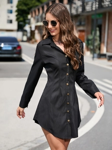 Detail view of a black long sleeve mini shirt dress with vintage gold buttons and collar
