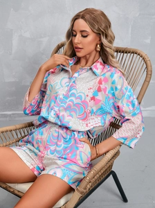 Detailed macro view of vibrant abstract print on a summer shirt and shorts set for women