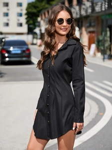 Detailed view of the black long-sleeve shirt dress with vintage metal buttons and collar