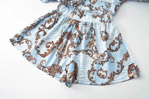 Detailed view of high waist shorts featuring baroque gold scrolls and tiger print pattern