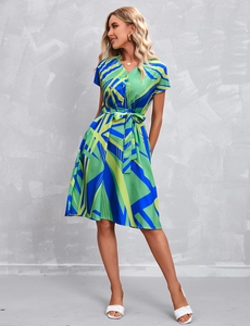Detail of V-neck short sleeve dress featuring geometric print and belted waist design