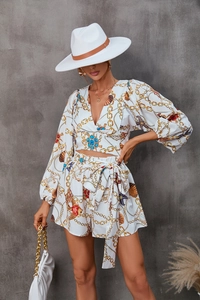 Close-up of nautical print long sleeve V-neck top with gold chain and jewel patterns