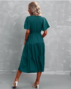 Back view of a tiered dark green midi dress with layered ruffles and butterfly short sleeves
