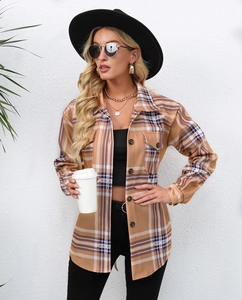 Detail of a brown and navy plaid long-sleeve shacket with buttons and chest pockets