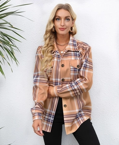 Detail of tan plaid shacket featuring front buttons and dual chest pockets for women