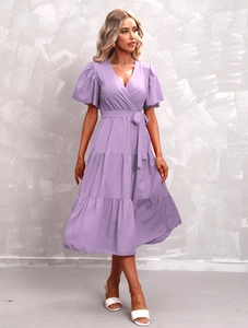 Detail of light purple V-neck wrap dress with ruffle sleeves and tiered skirt texture