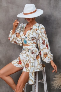 Detail of V-neck long sleeve floral top and high waist shorts with marine print
