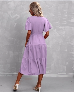 Detail of lavender tiered midi dress featuring flutter sleeves and a matching tie belt