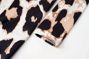Close-up of zebra pattern cuff with detailed stitching on a long sleeve dress
