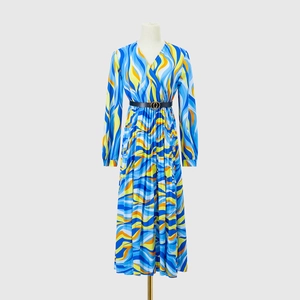 Detail view of V-neck long sleeve dress with colorful wavy print and metal buckle belt