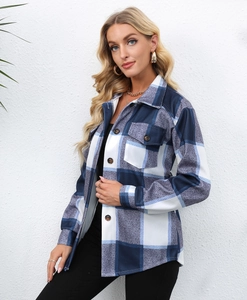 Detail view of plaid print long sleeve shirt jacket featuring front flap pockets and buttons