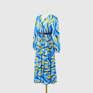 Detail of V-neck long sleeve maxi dress featuring wavy geometric prints and belted waist