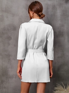 Back view of white blazer dress showing slim fit waist and 3/4 puff sleeve details