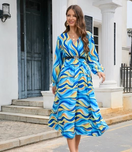 Detail of V-neck long sleeve dress with colorful wave print and gold buckle belt