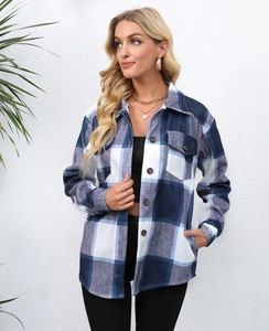 Close-up of blue and grey plaid flannel shacket with amber buttons and chest pocket