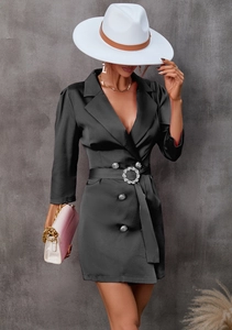 Detail of black satin blazer dress with rhinestone buckle and three-quarter sleeves