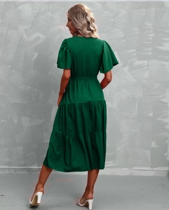 Detail of dark green V-neck dress with ruffled sleeves and layered tiered skirt