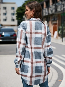 Detailed view of long plaid shacket with brushed wool fabric and curved hem design