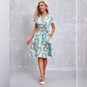 Elegant light blue short sleeve V-neck dress with abstract swirl prints and waist tie