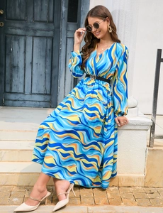 Detail shot of V-neck printed long sleeve dress with waist belt and gold buckle