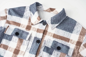Detail of plaid long coat collar and button pockets with thick wool texture