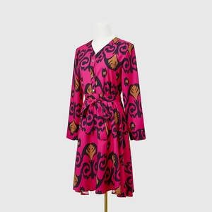 Detail of V-neck printed dress with metallic buttons and adjustable waist tie