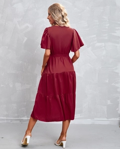 Detail view of burgundy tiered midi dress with flutter sleeves and waist tie belt
