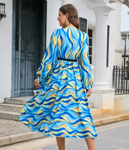 Detail view of the colorful abstract wavy print and high waist on this long sleeve dress