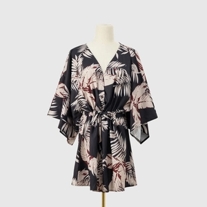 Detail of V-neck summer dress featuring tropical leaf print and adjustable waist drawstring
