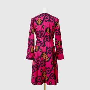 Close-up of fuchsia printed long sleeve dress with waist tie and abstract art patterns