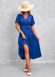 Detail of royal blue V-neck dress featuring flutter sleeves and a tiered ruffle skirt