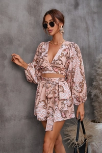 Detail of V-neck long sleeve floral top and high waist shorts with baroque zebra print
