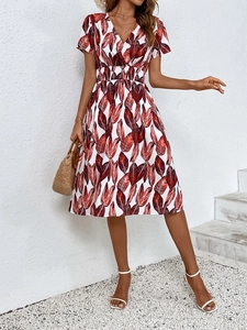 Detail of V-neck floral midi dress with red leaf print and elastic high waist design