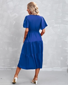 Rear view detail of cobalt blue V-neck dress with ruffled sleeves and tiered cake skirt