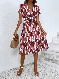 Detail view of v-neck floral dress with smocked waist and delicate leaf print patterns
