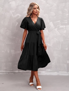 Detailed view of black V-neck tiered midi dress with ruffle sleeves and waist tie belt