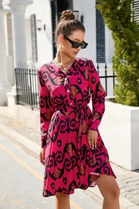 Detail of V-neck and pearl buttons on a vibrant fuchsia pink abstract print dress