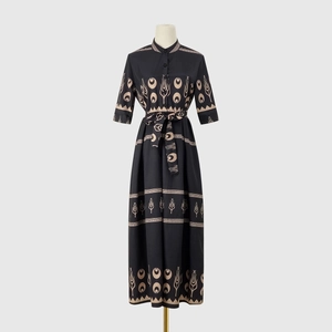 Detail of ethnic tulip and crescent print on a black mid-sleeve maxi dress fabric