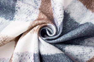 Macro detail showing the soft texture and plaid pattern of thick winter wool coat fabric