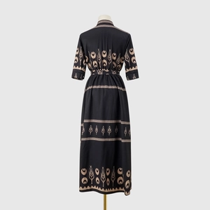 Detail of ethnic floral print on black midi dress with waist belt and mandarin collar