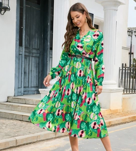 Detail of V-neck printed dress with colorful patterns and black belt with golden buckle