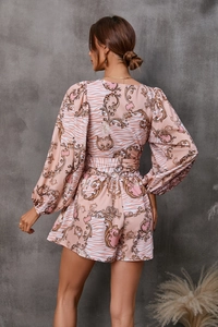 Detail of floral romper back with gold baroque patterns and orange zebra print