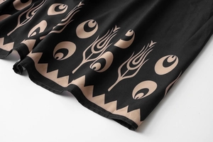 Detail of bohemian floral print and geometric hem on black lightweight summer dress