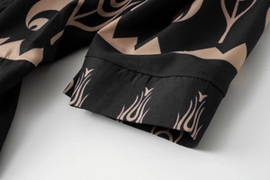 Close-up detail of ethnic print patterns and twill texture on a women's summer dress sleeve