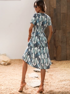 Detail view of summer floral print dress showing elastic high waist and irregular hemline