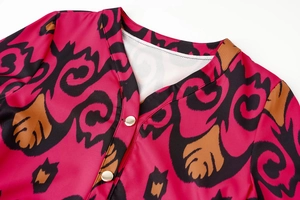 Detail of rose red bohemian floral dress with V-neckline and gold metal buttons