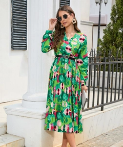 Detail of V-neck printed long sleeve dress with waist pleats and stylish green patterns