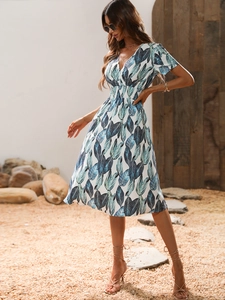Detail of floral V-neck dress with elastic waist and delicate leaf print patterns