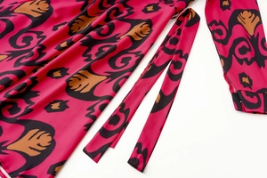 Detail of bohemian abstract print on smooth satin fabric with matching waist tie